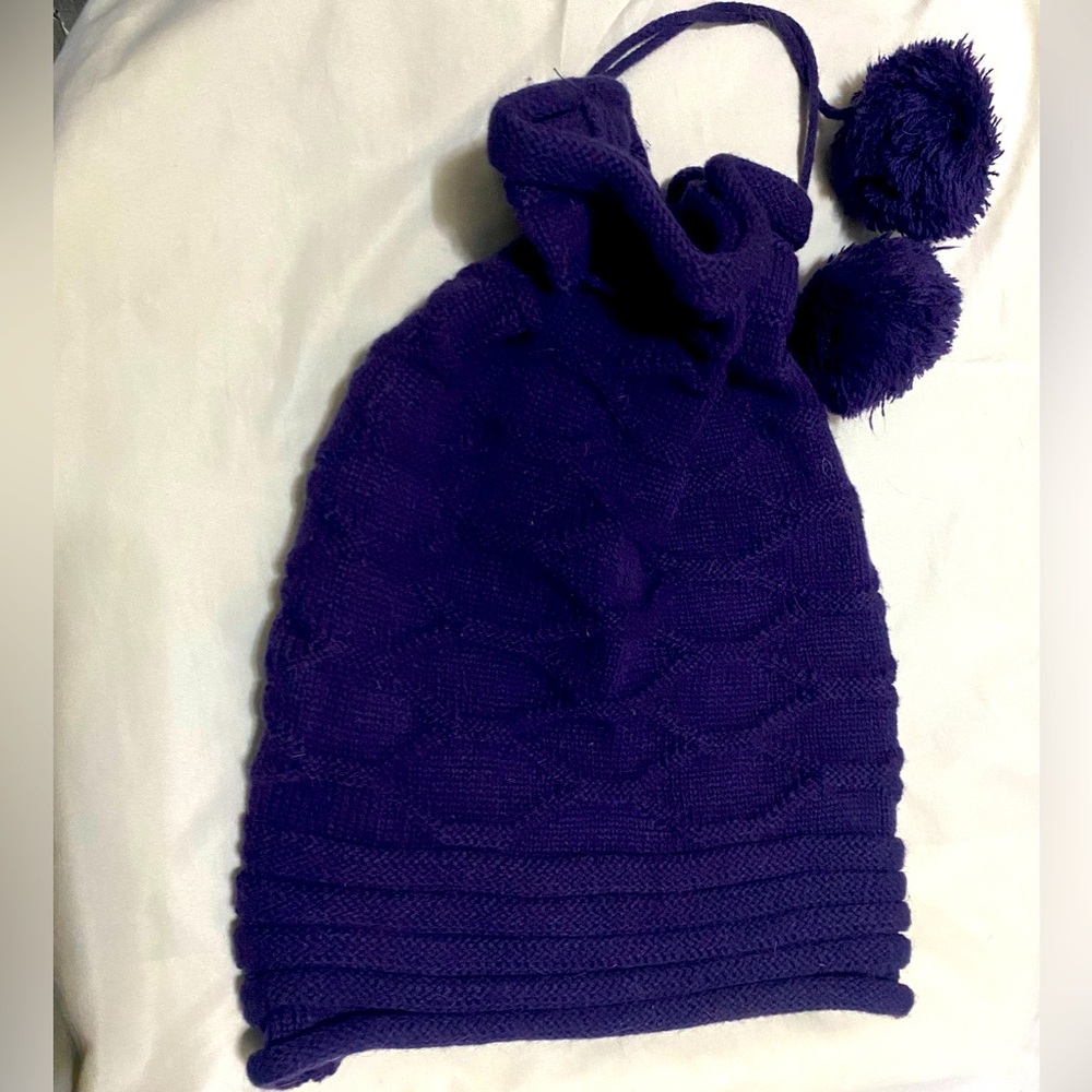 purple winter hat with pom poms